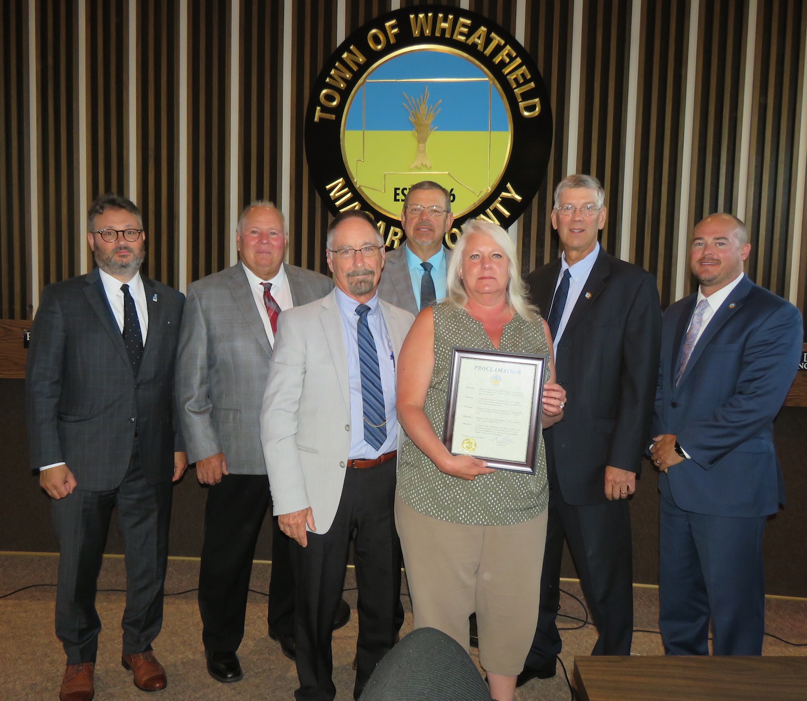 Pictured, at left, with the proclamation, from left, Town Attorney Matthew Brooks, Councilman Gil Doucet, MacSwan, Councilman Randy Retzlaff, Grawe, and councilmen Larry Helwig and Curt Doktor. 